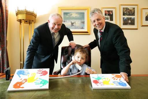 Oscar Knox pictured with Martin McGuinness and Peter Robinson. Pic: Presseye